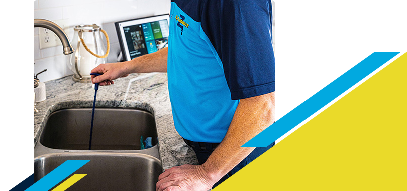 Z PLUMBERZ technician unclogging drain