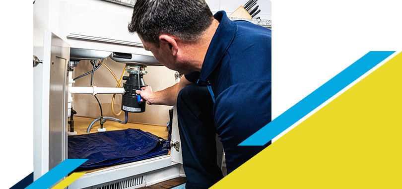 Z PLUMBERZ technician fixing garbage disposal